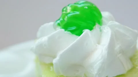 Kiwi pudding with green cherry on top closeup Stock Footage 54227510