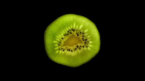 Kiwi Slice Rotating on Black Background in 60p Stock Footage 337014345