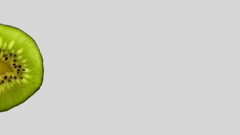 Kiwi Slice Rotating on White Background in 60p Stock Footage 337014186