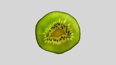 Kiwi Slice Rotating on White Background in 60p Stock Footage 337014211
