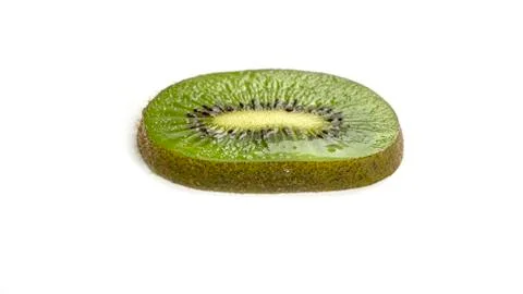 Kiwi slice on a white background. Macro photo. Stock Photos