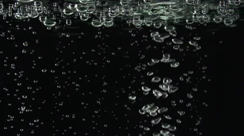 Kiwi slices falling down into the water Stock Footage 22243950
