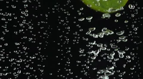 Kiwi slices falling down into the water Stock Footage 22244082