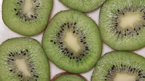 Kiwi slices rotation on white table. Stock Footage 128764249