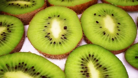 Kiwi slices texture pattern on rotating plate food hd video looping clip Stock Footage 98390113
