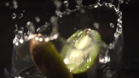 Kiwi slow motion closeup falling in water with Splash macro Stock Footage 124734898