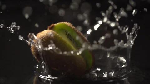 Kiwi slow motion closeup falling in water macro Stock Footage 125337054