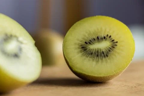 Kiwi split in half, representing half, split or separation. Concept of being  Stock Photos