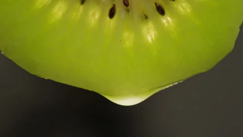 Kiwi with water close-up macro. Slice fresh exotic kiwi fruit texture background Stock Footage 260414183
