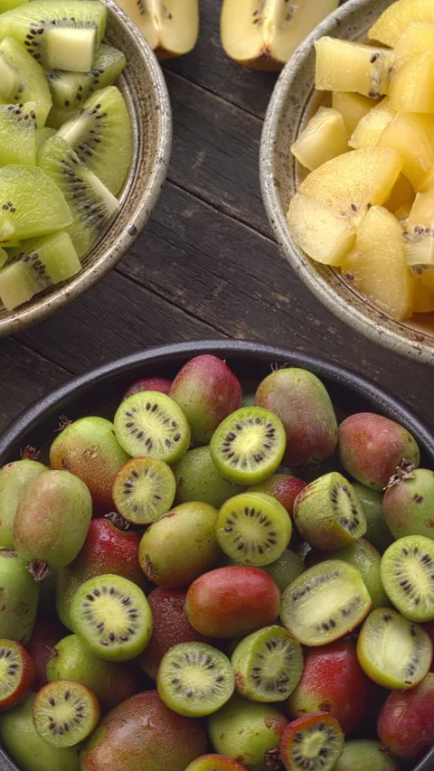 Kiwifruits of different types. Vertical video. Video stock 308253740