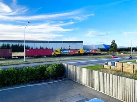 KiwiRail freight train with DL class locomotive and shipping containers pas.. Stock Photos