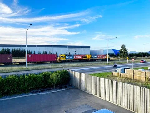 KiwiRail freight train with DL class locomotive hauling intermodal shipping.. Stock Photos