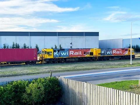 KiwiRail freight train with DXC class locomotives pulling red intermodal sh.. Stock Photos