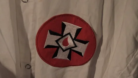 KKK Robe Cross patch and mask closeup Stock Footage 129474785