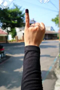 KLATEN, INDONESIA – APRIL/17/2019: Voter's Finger on Indonesia's Election Day Stock Photos