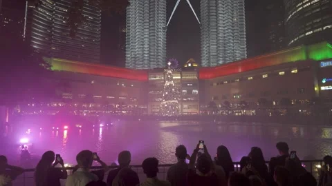 KLCC marks 25 years with a dazzling Symphony Lake Fountain Show Video stock 317308705