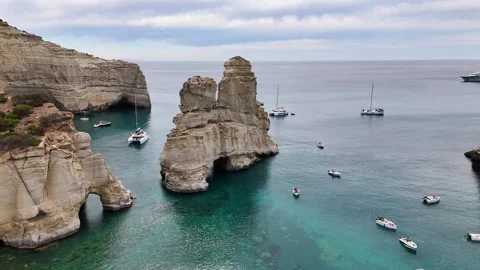 Kleftiko landmark sea stack and volcanic cliffs with motorboats and sailboats Stock Footage 344919346