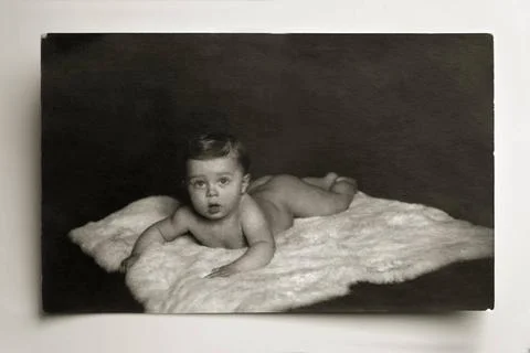 Kleinkind auf Eisbaerenfell, ca. 1920 Auf dem Bauch liegendes nacktes Klei... Stock Photos