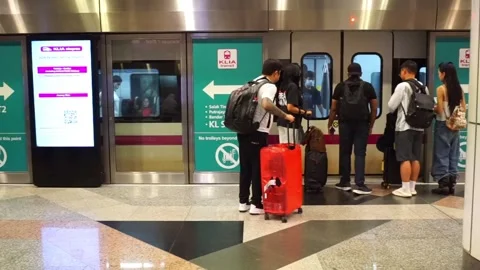 KLIA Express train under the supervision of terminal staff. Stock Footage 320145909