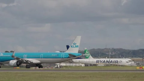 KLM plane on the runway with view of ryanair in the background Stock Footage 336693839