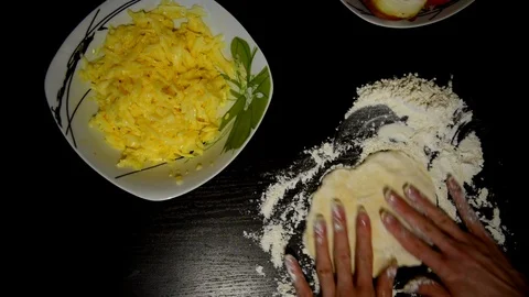 Knead the dough on a dark table Stock Footage 124723294