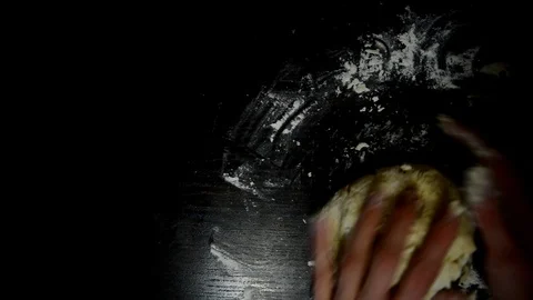 Knead the dough on a dark table Stock Footage 124723355