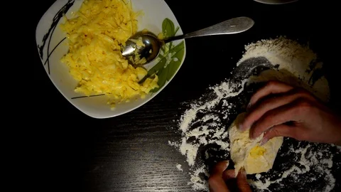 Knead the dough on a dark table Stock Footage 124723562