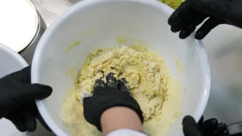 Knead dough by hand Hands kneading raw dough on table flat lay. Top view on Video stock 284435541