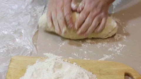 Knead the dough with your hands on the table Stock Footage 126362285