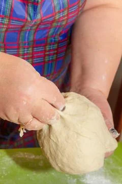 Knead the dough with your hands on the table Stock Photos