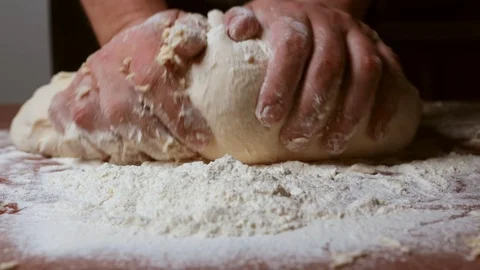 Knead a large mass of dough on the table Stock Footage 124960099
