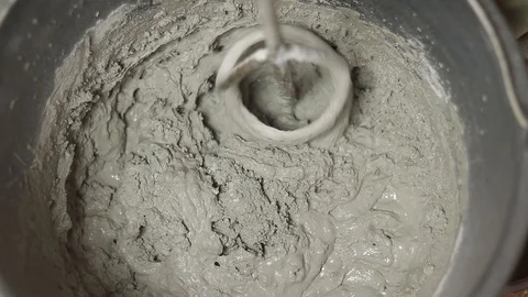 Knead the solution in a bucket. Knead the solution with a mixer. Stock Footage 129138022