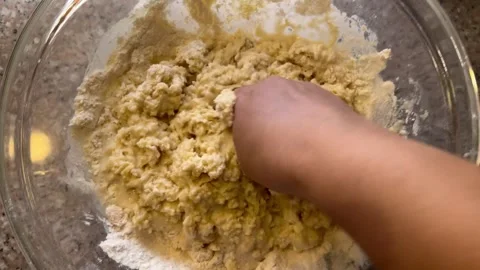 Kneading and Combining Ingredients by Hand in a Mixing Bowl Stock Footage 345522335