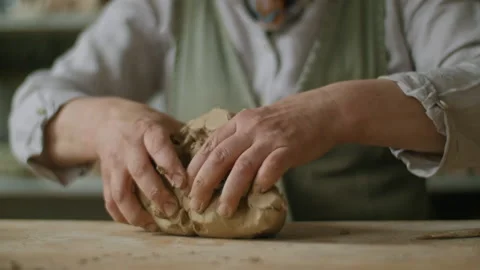 Kneading a big piece of clay Stock Footage 218603864