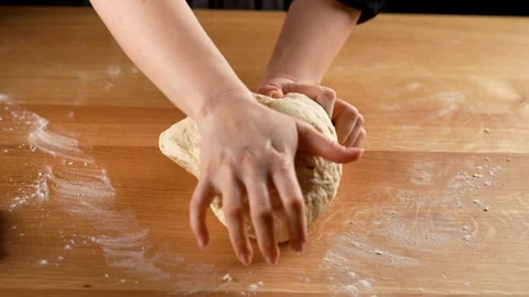 Kneading bread dough by female hands in slow motion 4K - 120fps with moody light Stock Footage 266218525