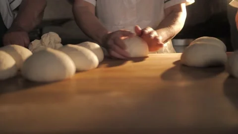 Kneading bread dough. Footage of chef making dough for donuts or pizza. Stock Footage 168533296