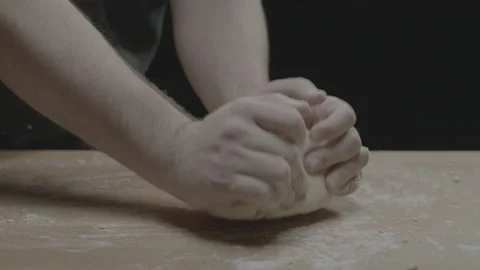 Kneading dough against a table as we push in Stock Footage 149116604