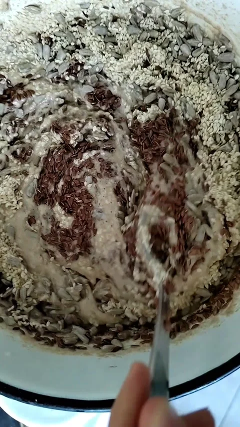 Kneading dough for bread on sourdough with flax, sesame and sunflower seeds 스톡 동영상 203221620