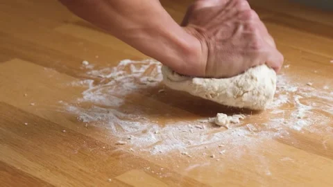 Kneading dough by hand on a wooden table (slow motion) 1 Stock Footage 206732553