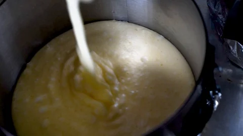 Kneading dough in a metal container for baking desserts Stock Footage 92586467