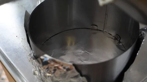 Kneading dough in a metal container for baking desserts Stock Footage 92586830