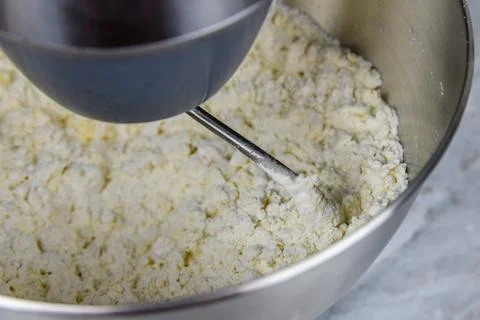 Kneading dough in a modern food processor on a kitchen table Фото