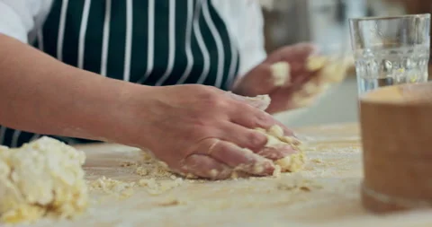 Kneading dough process close up shot selective focus woman's ahnds adding glass 库存影片 218646225