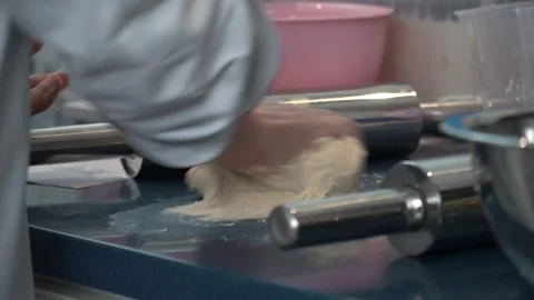 Kneading Dough in a Professional Kitchen Stock Footage 317472450