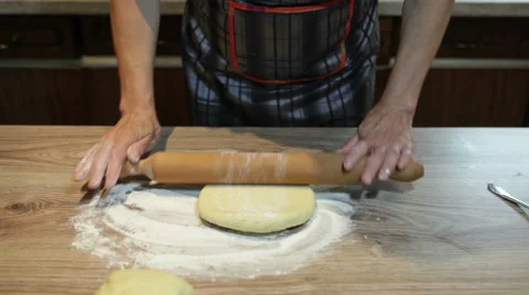 Kneading dough with rolling pin on table Stock Footage 57465505