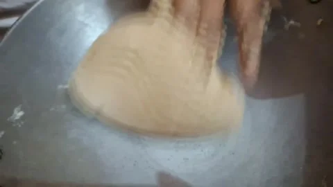 Kneading dough for roti involves mixing flour, Stock Footage 286362990