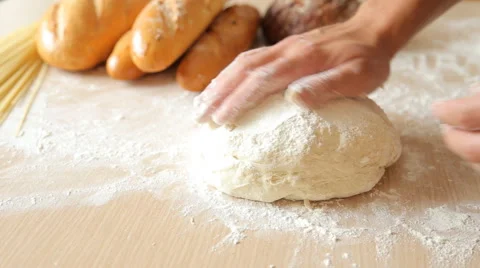 Kneading the dough on the table full of flour Stock Footage 65563115