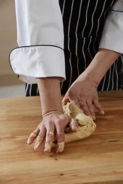 Kneading dough on table Foto stock
