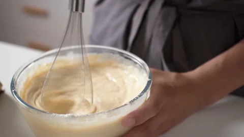 Kneading the dough with a whisk of a blender, making pancakes delicious brea 스톡 동영상 201754394