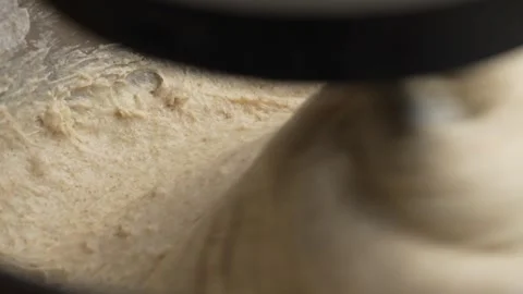 Kneading elastic dough for bread in a kneading machine in a bakery, close up Stock Footage 293132556